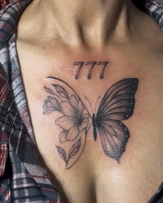 Black and grey butterfly and flower on the chest beneath the numbers 777