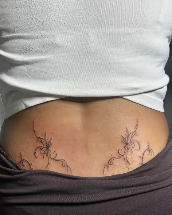 Delicate fine line vines across the lower back