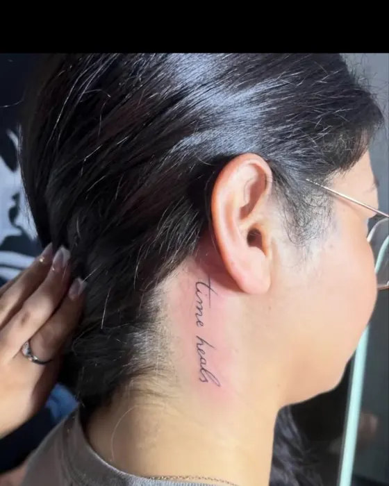 Small fine line script behind the ear