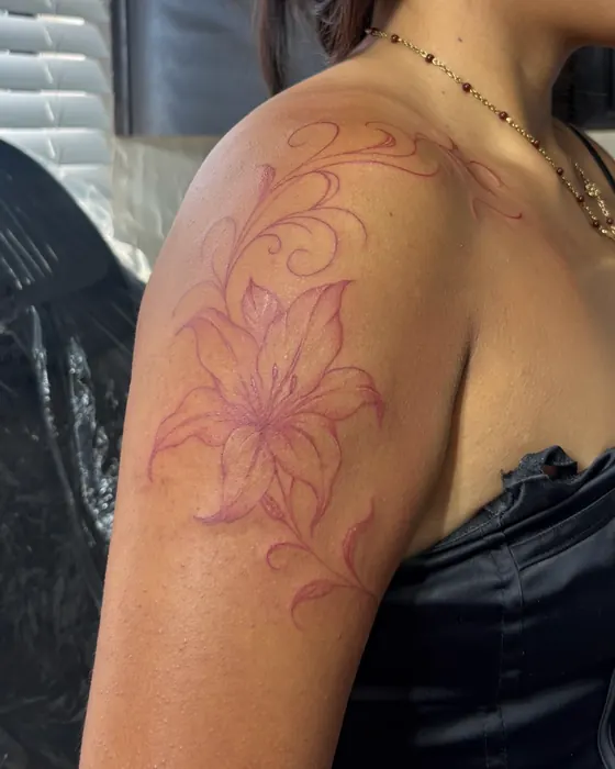 Red fine line lily and flourishes over the shoulder