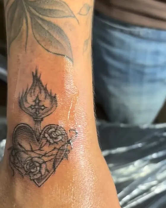 Black and grey sacred heart with roses on the forearm